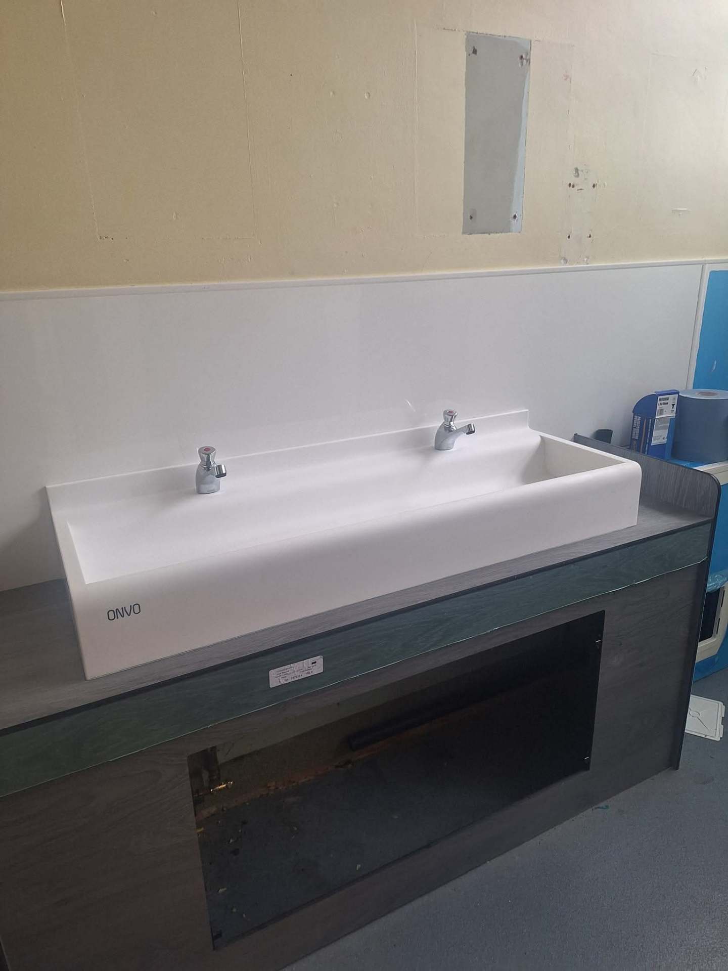 ONVO commercial trough basin with twin taps installed in a washroom refurbishment