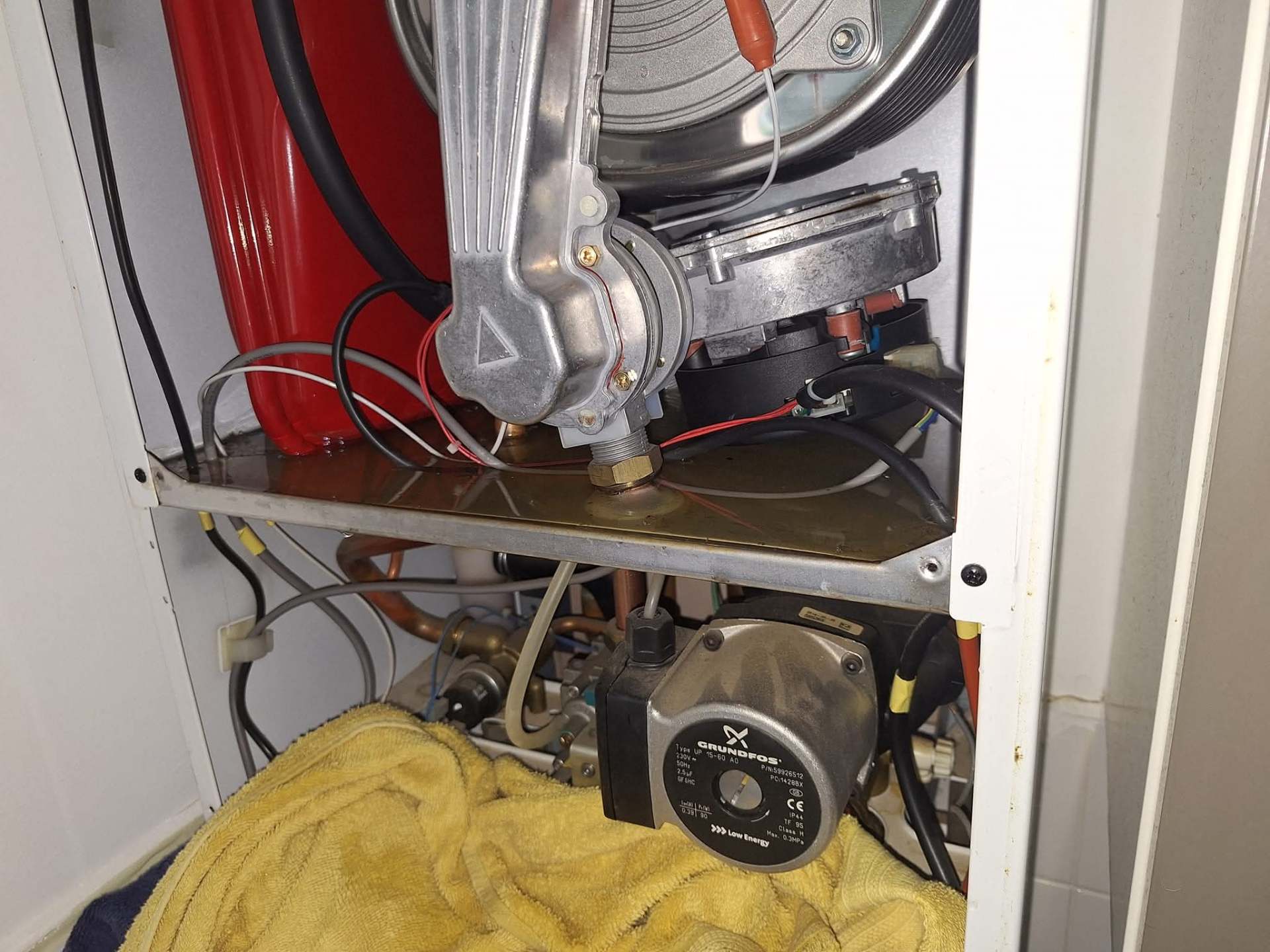 Boiler service close-up showing Grundfos pump and expansion vessel