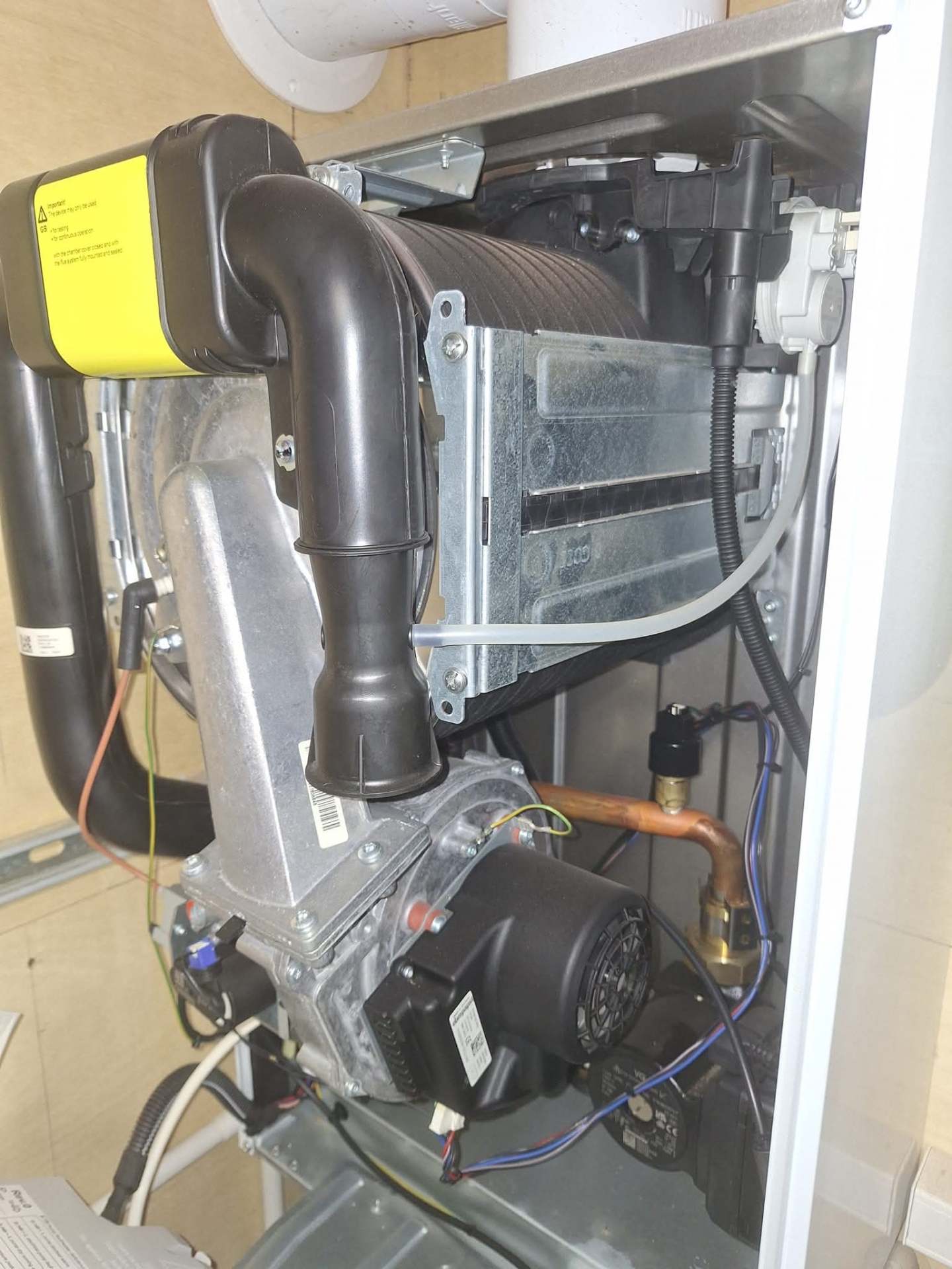 Inside view of a serviced boiler showing heat exchanger and gas valve