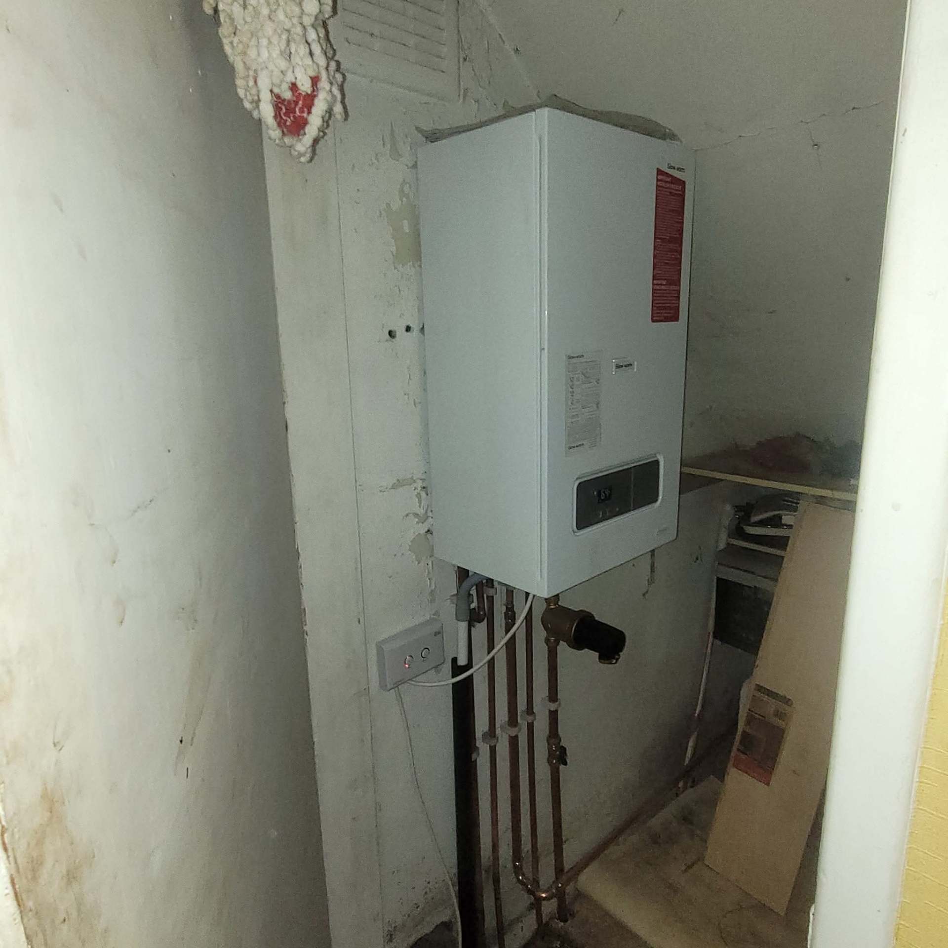 Wall-hung combi boiler installation with new flue and condensate run
