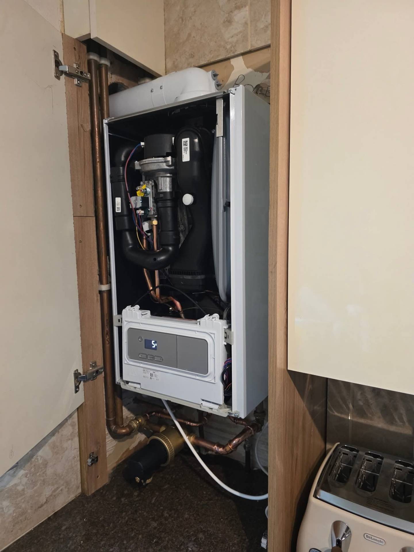 Glow-worm combi boiler diagnostics with cover removed during a same-day fault repair in Oldham